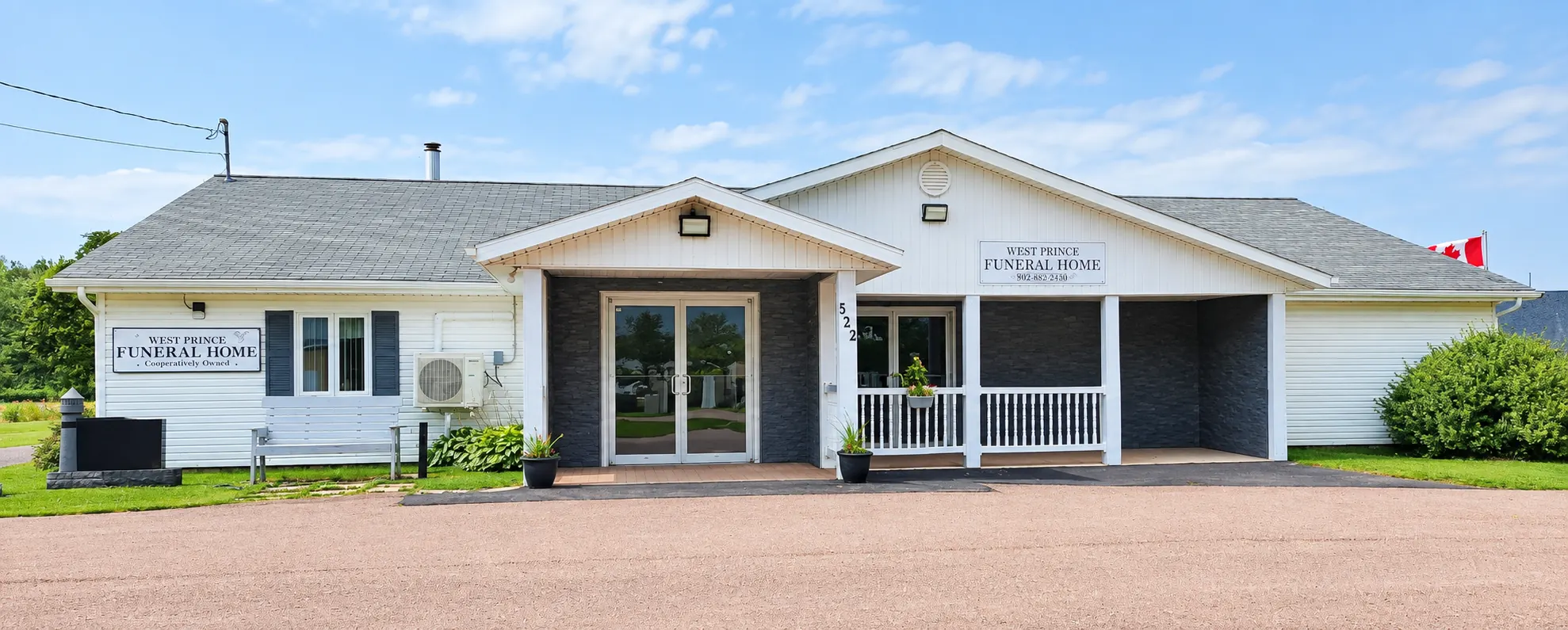 West Prince Funeral Home, a single-storey white building with a covered entrance on Thompson Road in Palmer Road, PEI